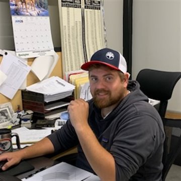 Luke Hince at his desk in the Alloway office