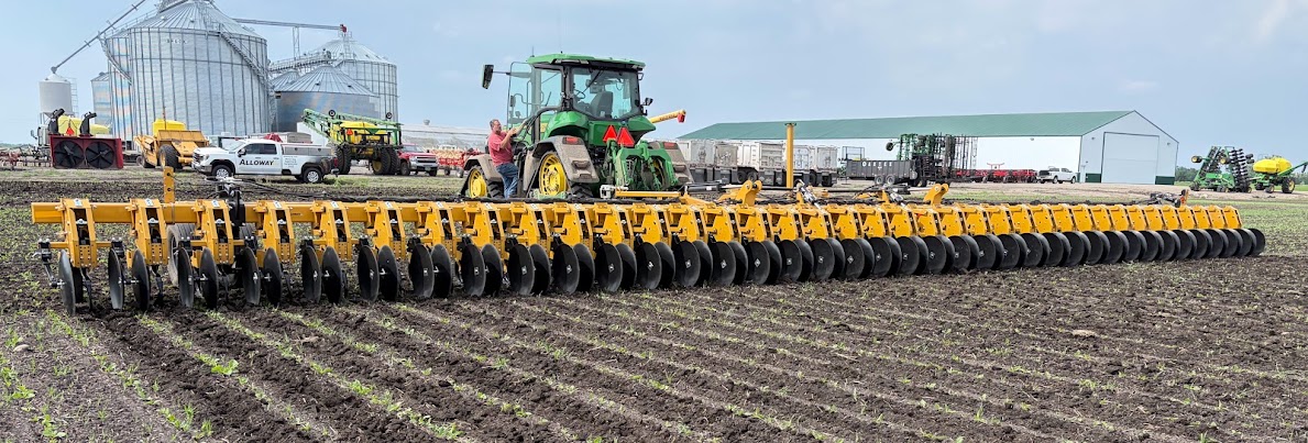 An Alloway row-crop cultivator behind a tractor in the field